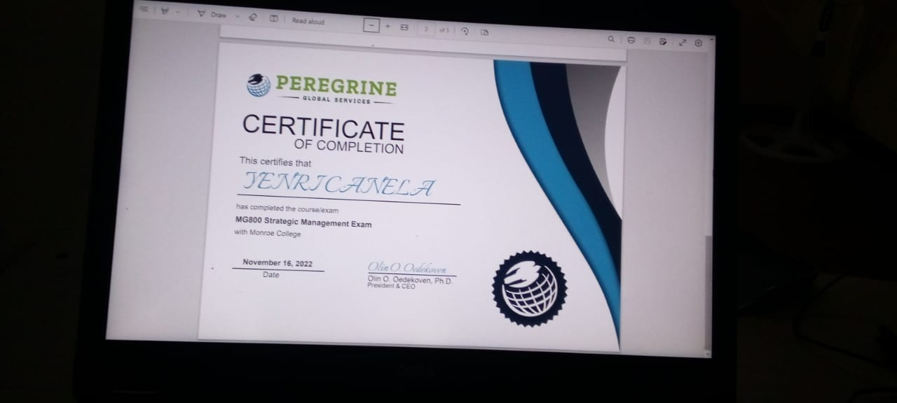 Photograph of a Peregrine Global Services Certificate of Completion issued to Yenri Canela for the MG800 Strategic Management Exam at Monroe College, dated November 16, 2022